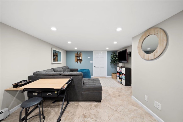 living area featuring baseboards, baseboard heating, and recessed lighting