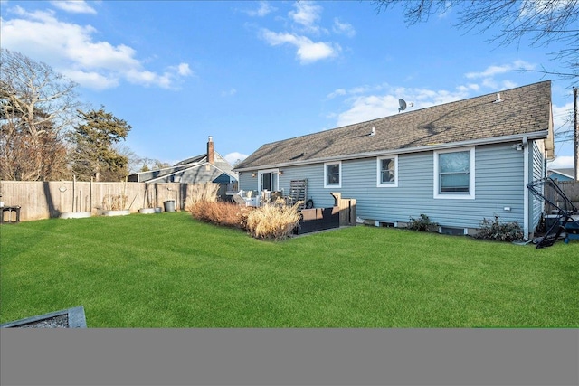 rear view of property featuring roof with shingles, a yard, an outdoor living space, and fence