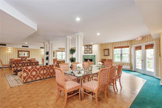 dining area with plenty of natural light, ornate columns, and light parquet floors