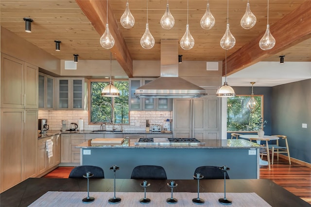 kitchen with glass insert cabinets, dark stone counters, and pendant lighting