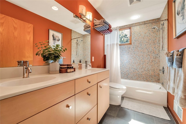 bathroom with double vanity, shower / tub combo with curtain, a sink, and tile patterned floors