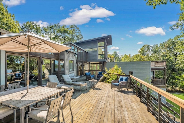 wooden terrace with outdoor dining area and an outdoor living space