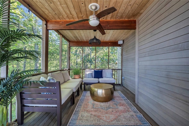 sunroom with ceiling fan, wooden ceiling, and beam ceiling