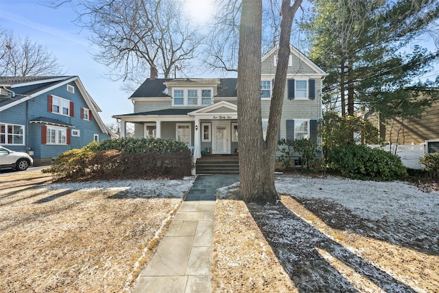 view of front of house with a porch and a chimney