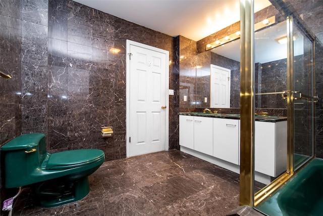 full bathroom with toilet, tile walls, bath / shower combo with glass door, and vanity