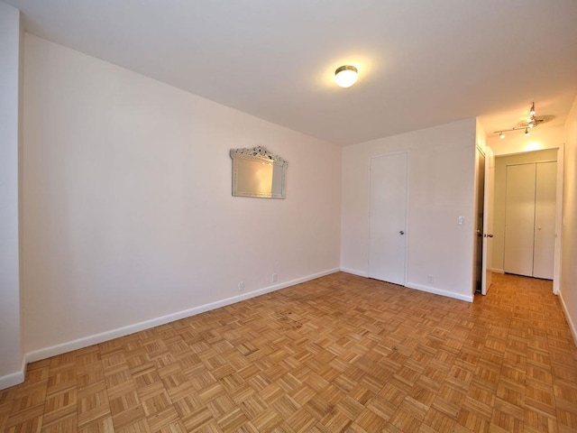 spare room featuring baseboards