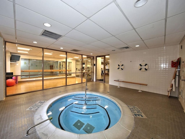 view of swimming pool with an indoor hot tub