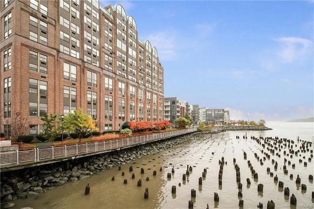 exterior space featuring a water view and a city view