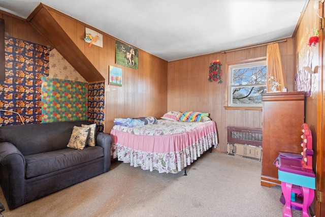 bedroom featuring light carpet and wooden walls