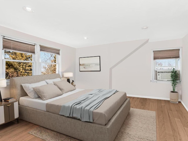 bedroom featuring light wood-style flooring, baseboards, cooling unit, and recessed lighting