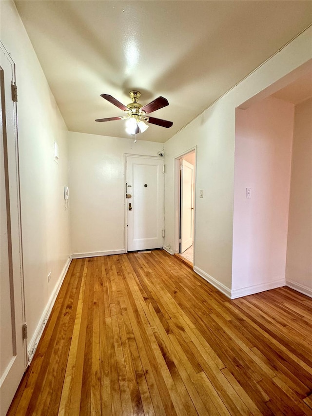 spare room with light wood-type flooring and ceiling fan