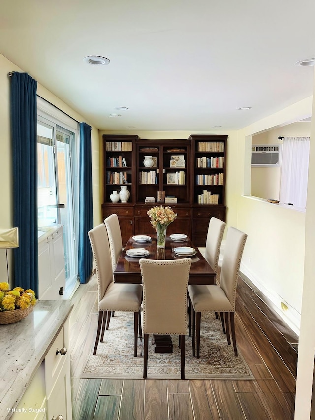 dining area with baseboards and wood finished floors