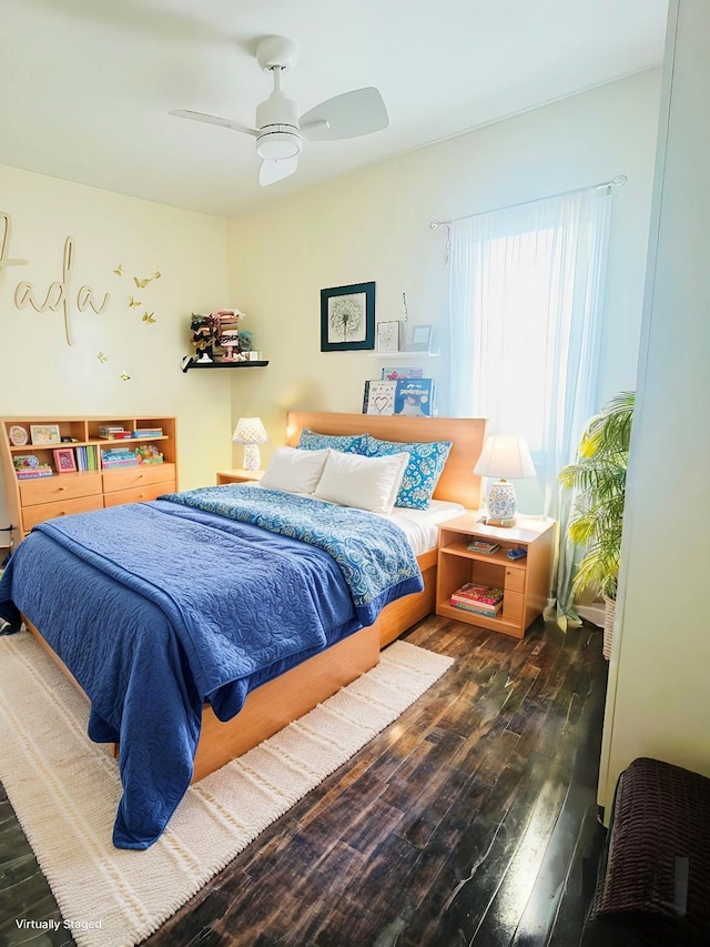 bedroom with ceiling fan and dark wood-style flooring