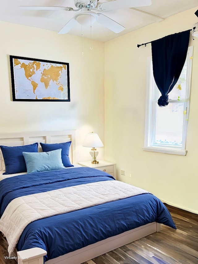 bedroom with wood finished floors and baseboards