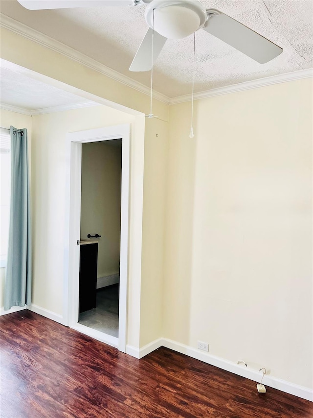 spare room featuring dark wood-style floors, ceiling fan, a textured ceiling, and crown molding