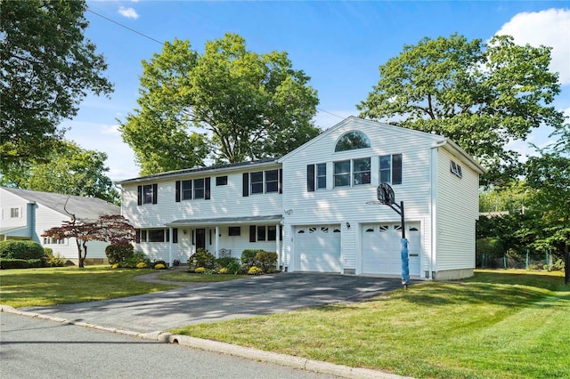 view of front of house featuring driveway, a garage, and a front yard