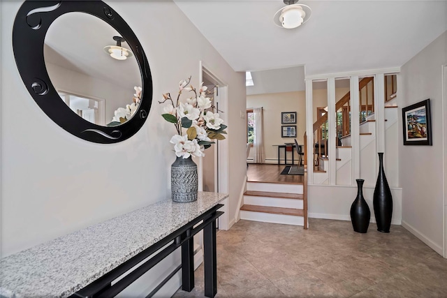 entryway with baseboards and stairs