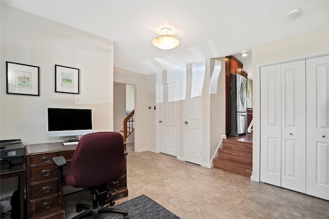 office space with light tile patterned floors and baseboards