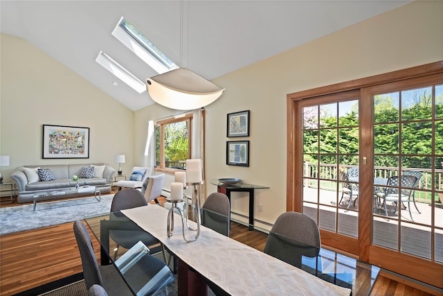 office area featuring lofted ceiling with skylight, baseboard heating, and wood finished floors