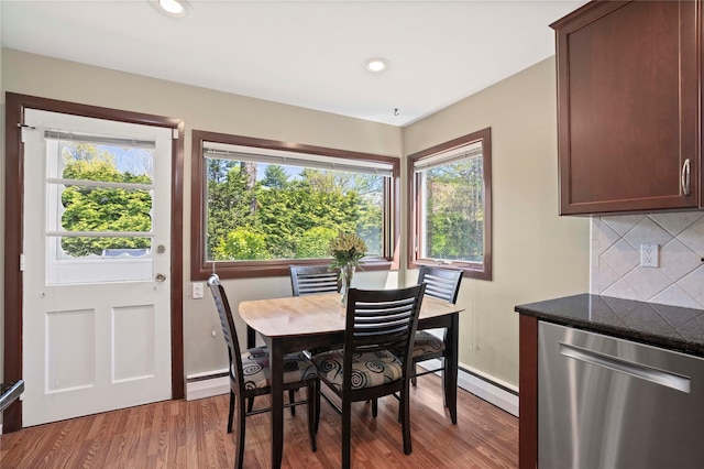 dining area featuring a baseboard heating unit, light wood-style floors, and recessed lighting