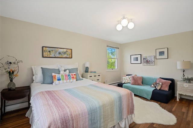 bedroom featuring baseboards, baseboard heating, and wood finished floors