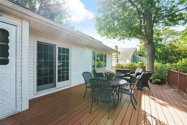 wooden terrace with outdoor dining area