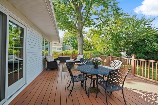 deck featuring outdoor lounge area and outdoor dining space