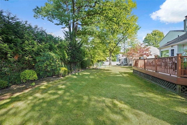 view of yard with fence and a wooden deck