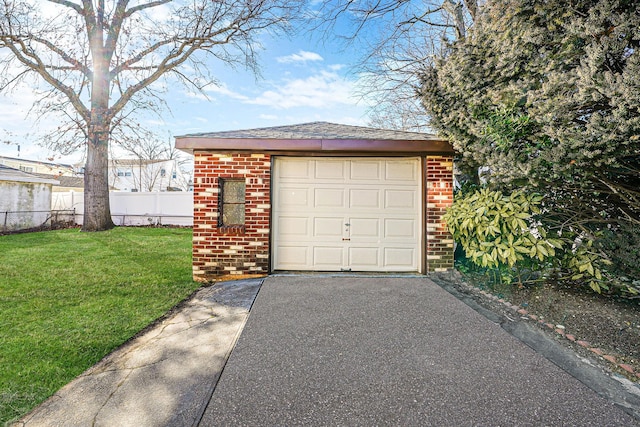 garage with driveway and fence