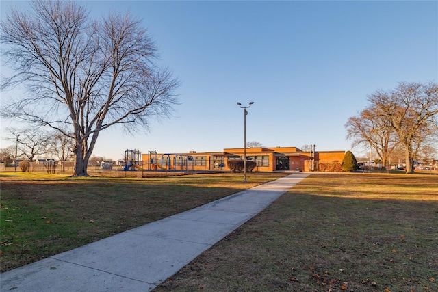 view of community with playground community and a yard