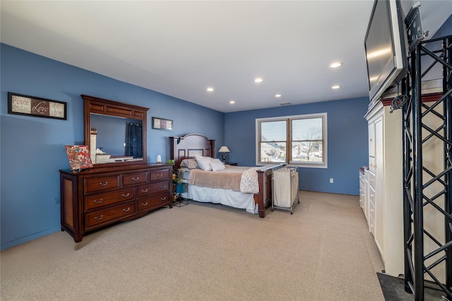 bedroom featuring light carpet and recessed lighting