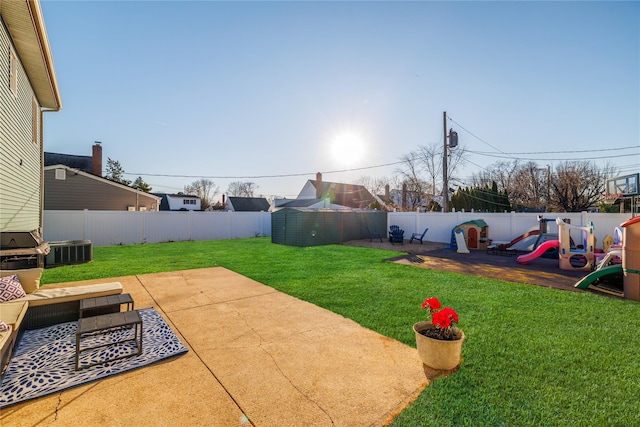 view of yard with a patio, a playground, and a fenced backyard