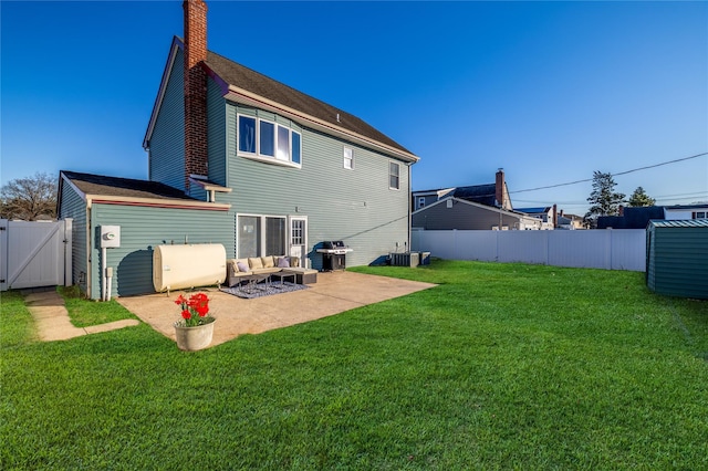 rear view of house with heating fuel, a fenced backyard, a patio area, and a yard