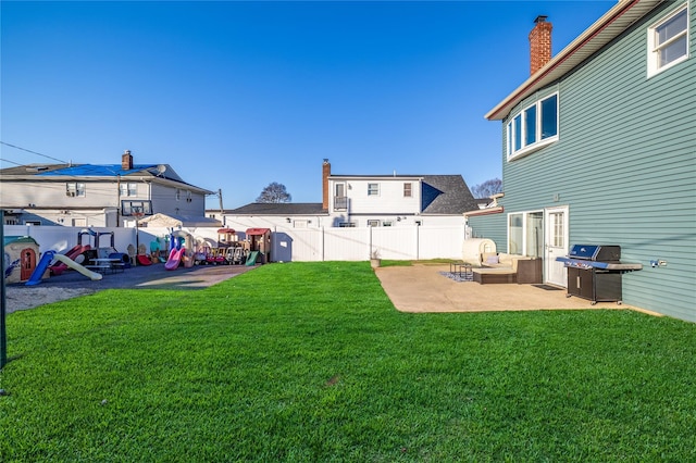 view of yard featuring a patio area, a fenced backyard, and a residential view