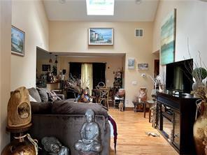 living room featuring lofted ceiling and wood-type flooring