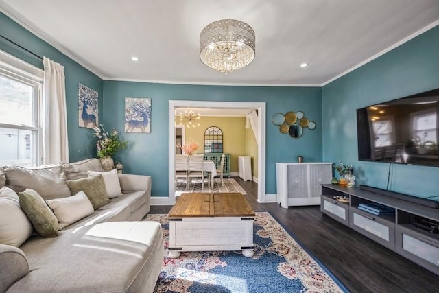 living room with dark hardwood / wood-style flooring, a notable chandelier, and ornamental molding