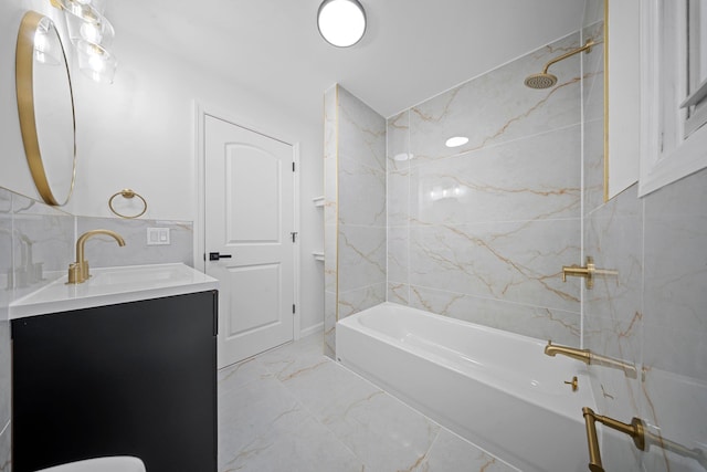 bathroom featuring vanity and tiled shower / bath