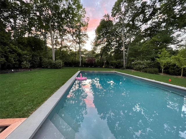 pool at dusk with a yard