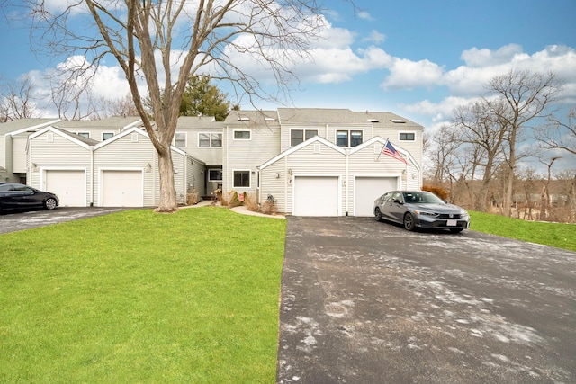 view of front of house with driveway, a garage, and a front lawn