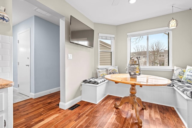 dining space featuring light wood-type flooring, visible vents, and breakfast area