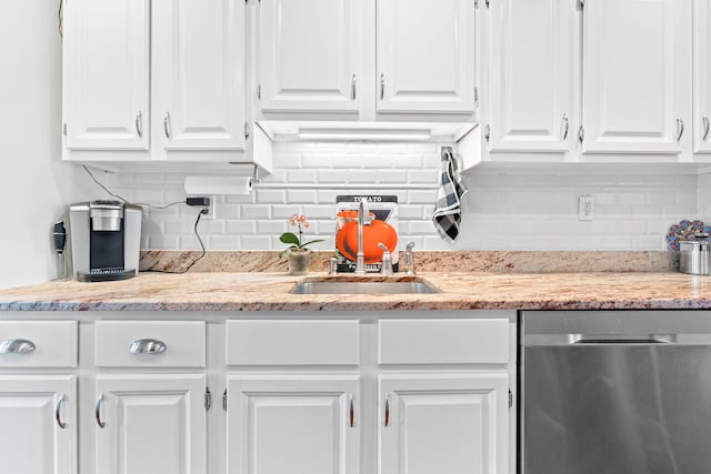 kitchen with tasteful backsplash, white cabinetry, and dishwasher