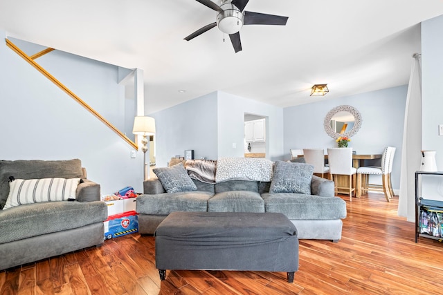 living area featuring a ceiling fan and light wood finished floors