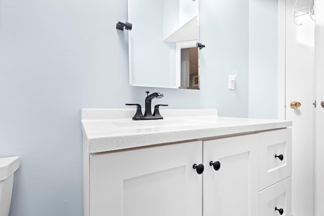 bathroom featuring toilet and vanity