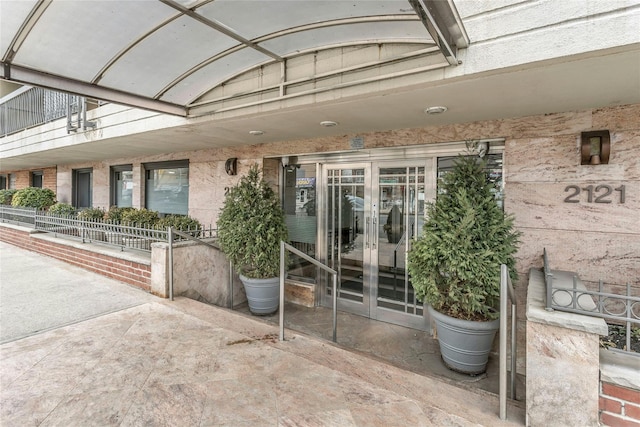 entrance to property featuring french doors and a patio area