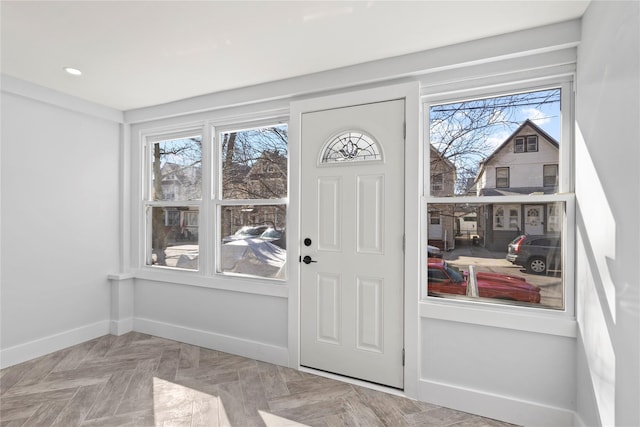 entryway with plenty of natural light, recessed lighting, and baseboards