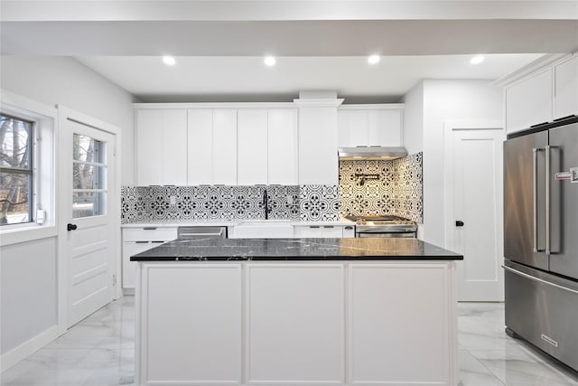 kitchen with a sink, stainless steel appliances, under cabinet range hood, white cabinetry, and marble finish floor