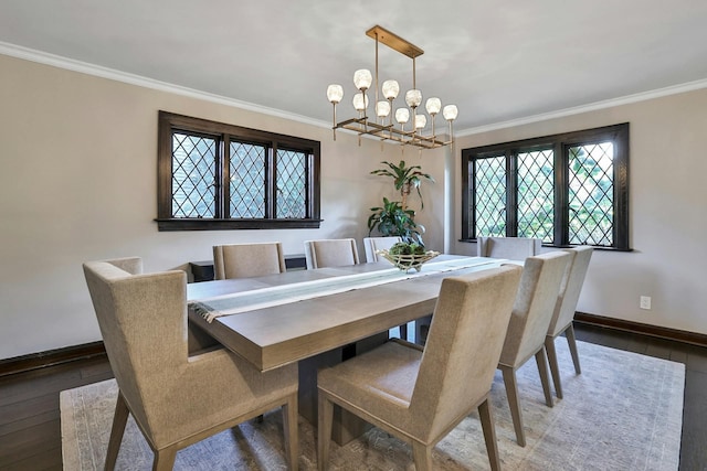 dining space featuring a notable chandelier, hardwood / wood-style floors, baseboards, and ornamental molding