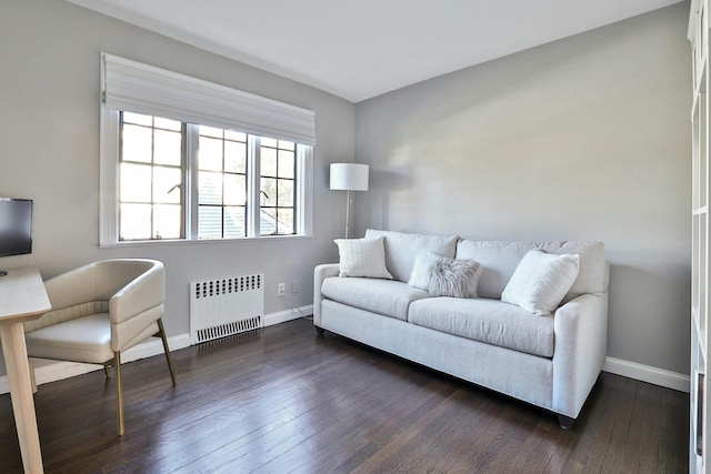 living area with baseboards, radiator, and dark wood-style floors