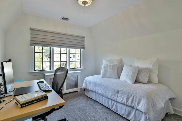 carpeted bedroom with radiator heating unit, baseboards, and visible vents