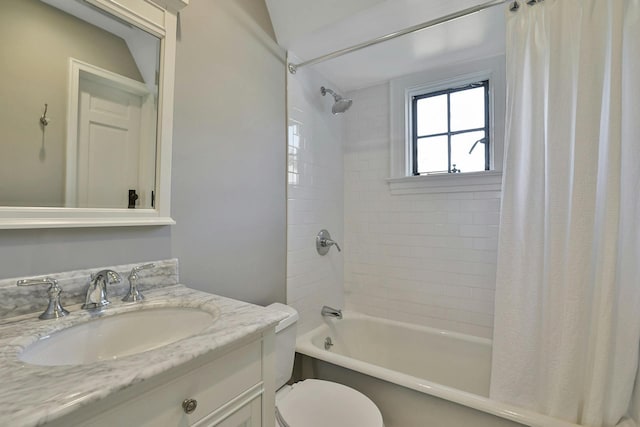 bathroom with vanity, shower / tub combo, and toilet